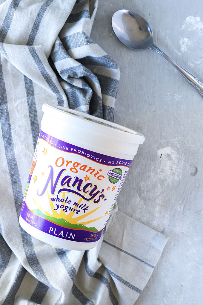 a container of yogurt on a napkin
