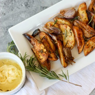 crunchy oven baked fries on a white rectangular plate next to dish of aioli
