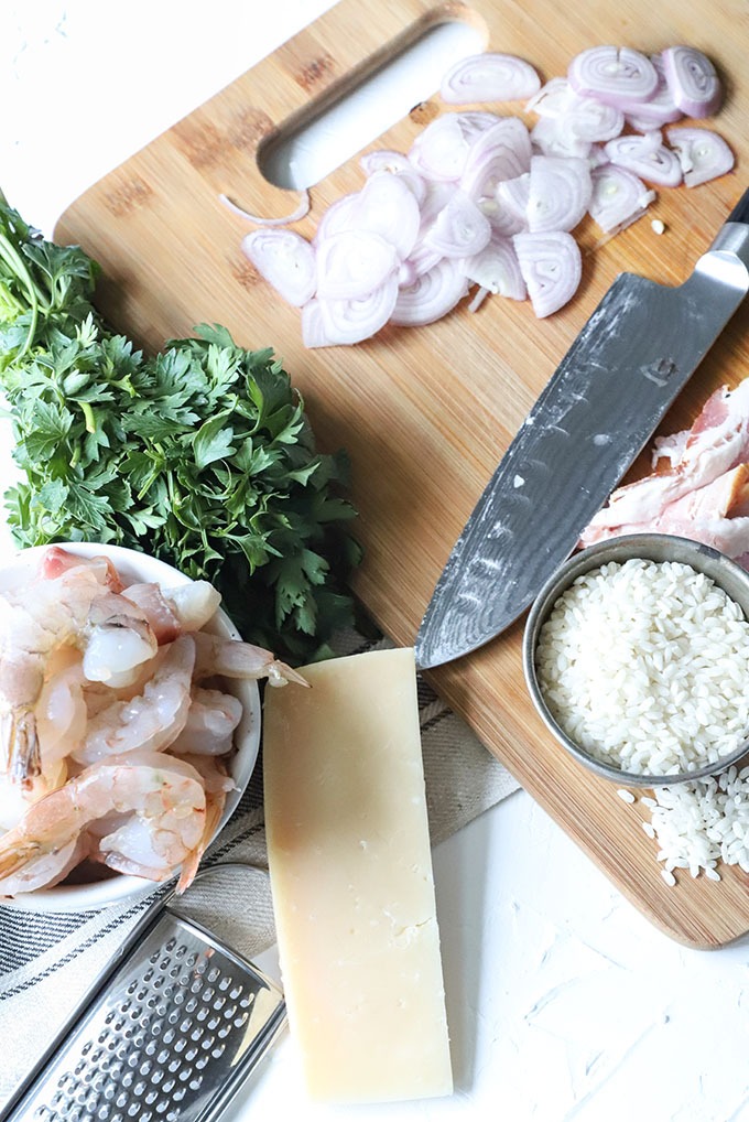prawn risotto ingredients on wooden board